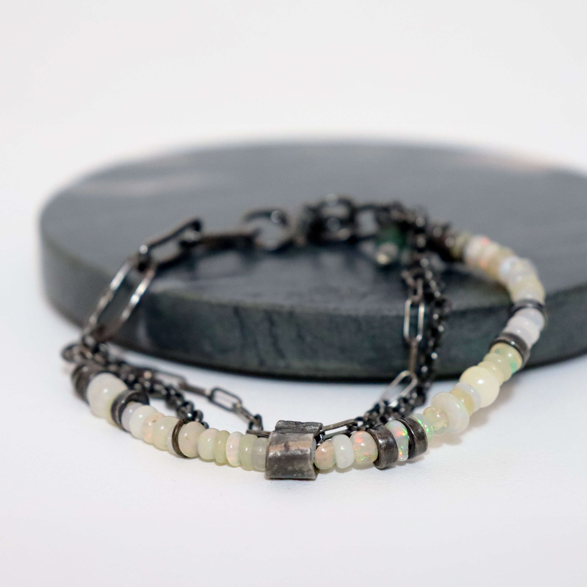 loose boho bracelet with opal beads and silver chains, closes with round lobster clasp, hand forged silver links, made by roff jewellery