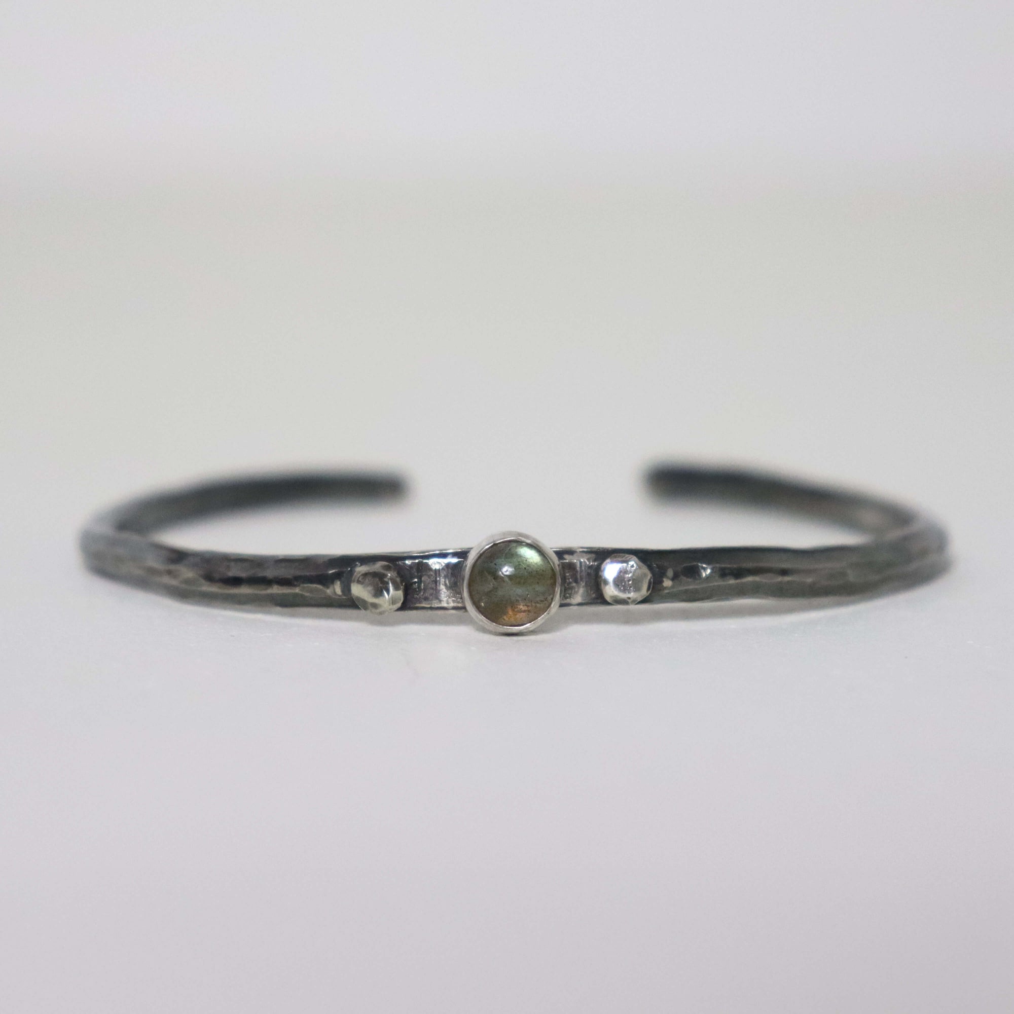 Handmade hammered silver cuff with round green labradorite
