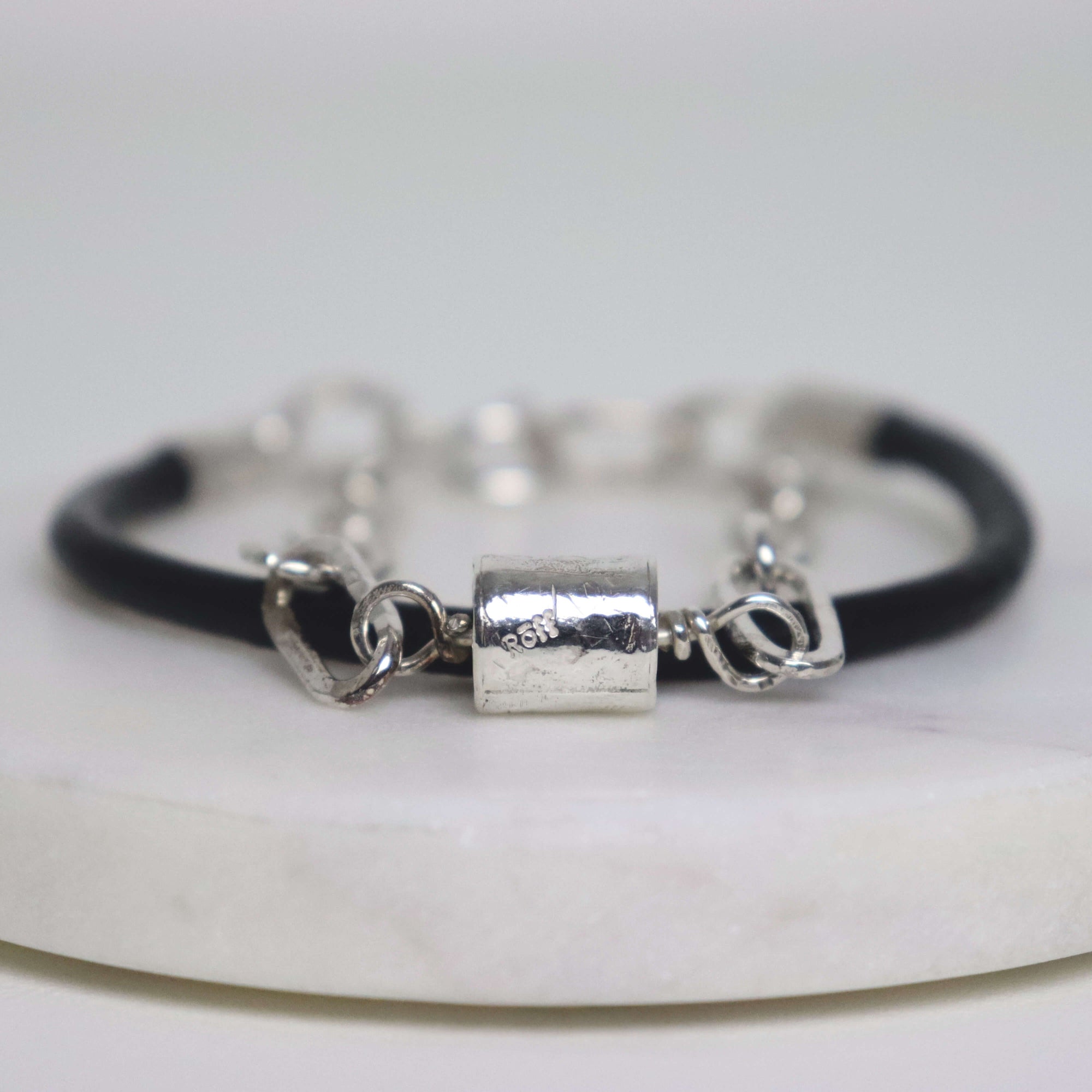 Bold silver link bracelet with black leather, handcrafted by roff