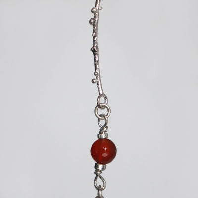 red carnelian bead and inspired by nature long silver links with granules, made by hand by saskia van der donk aka roff jewellery