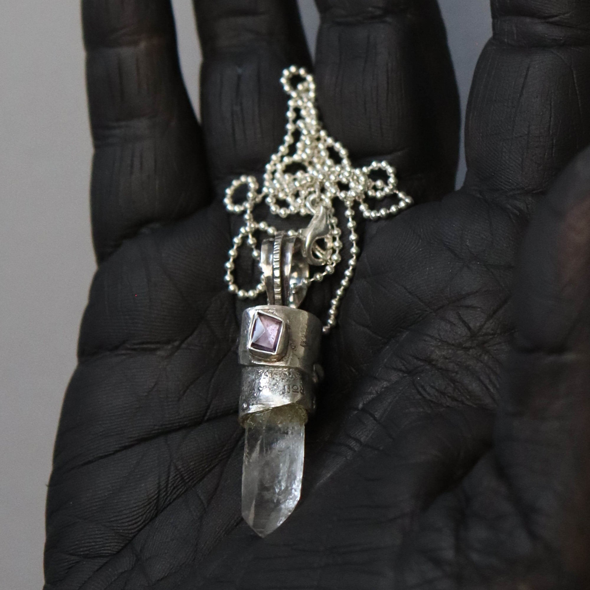 Raw crystal necklace with distressed silver setting and purple spinel, artisan made by roff
