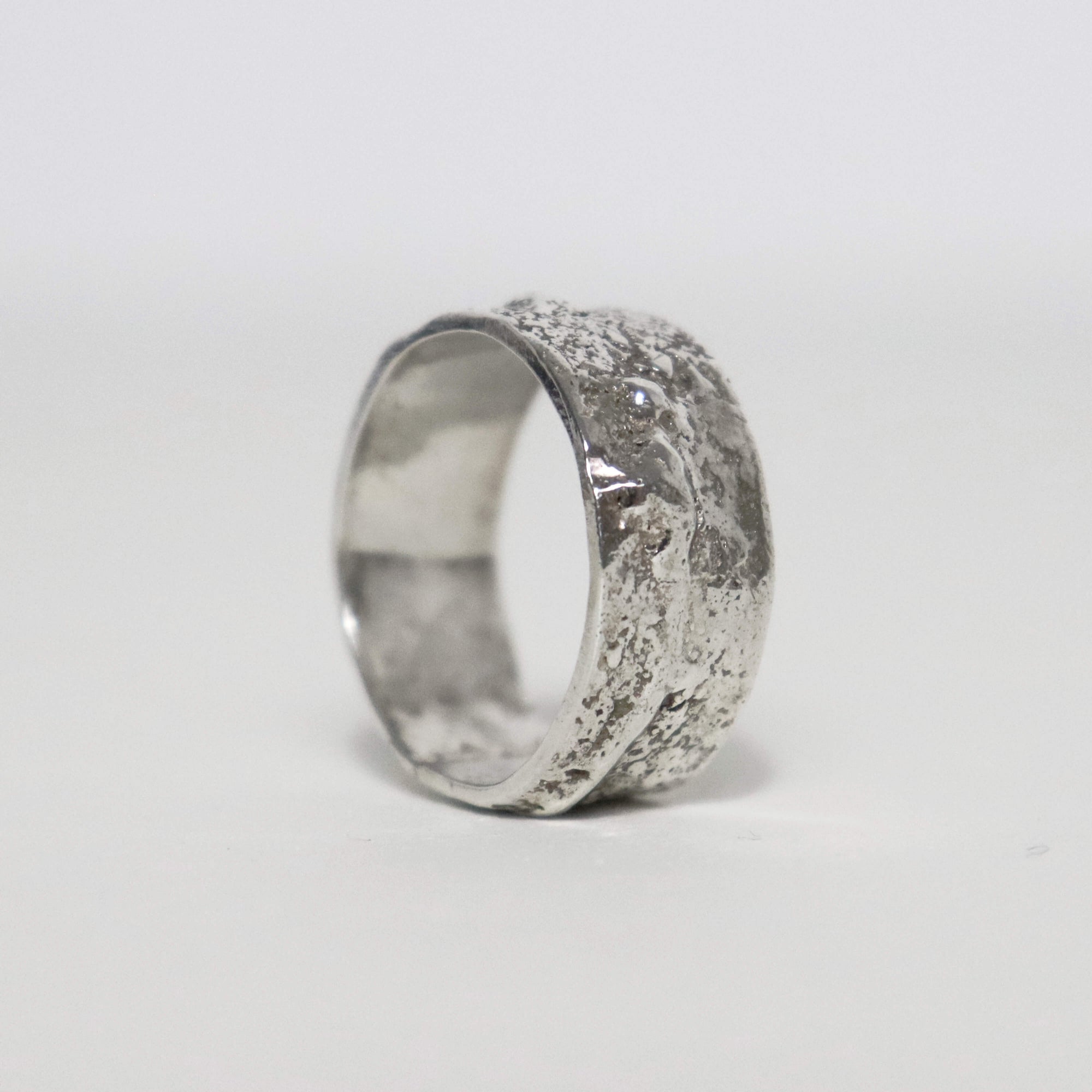 Handmade wide sterling silver ring with thick fused silver blobs, oxidized details and sculptural molten texture.