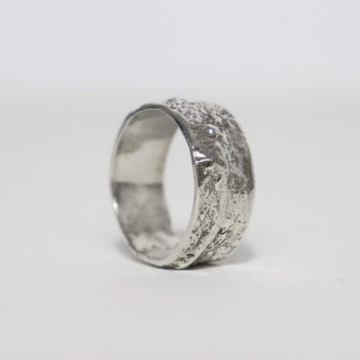 Handmade wide sterling silver ring with thick fused silver blobs, oxidized details and sculptural molten texture.
