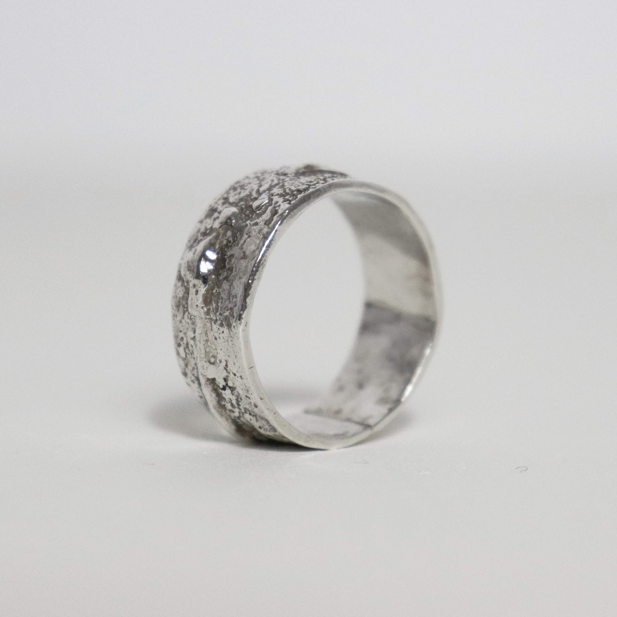 Chunky textured sterling silver band showing raised silver nodules and a smooth polished interior