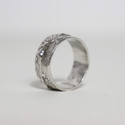 Chunky textured sterling silver band showing raised silver nodules and a smooth polished interior