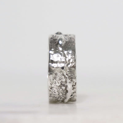 Wide men's sterling silver ring with irregular fused metal texture, polished silver patches and dark oxidized recesses