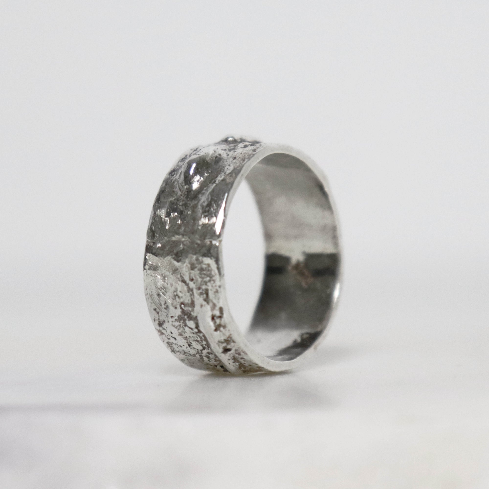 Handcrafted 9 mm wide sterling silver thumb ring with sculptural raised texture and polished inner band