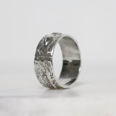 Handcrafted 9 mm wide sterling silver thumb ring with sculptural raised texture and polished inner band