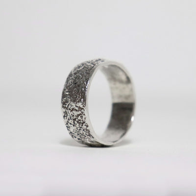 Handmade textured sterling silver men's ring with fused silver sawdust surface, oxidized finish and polished interior.