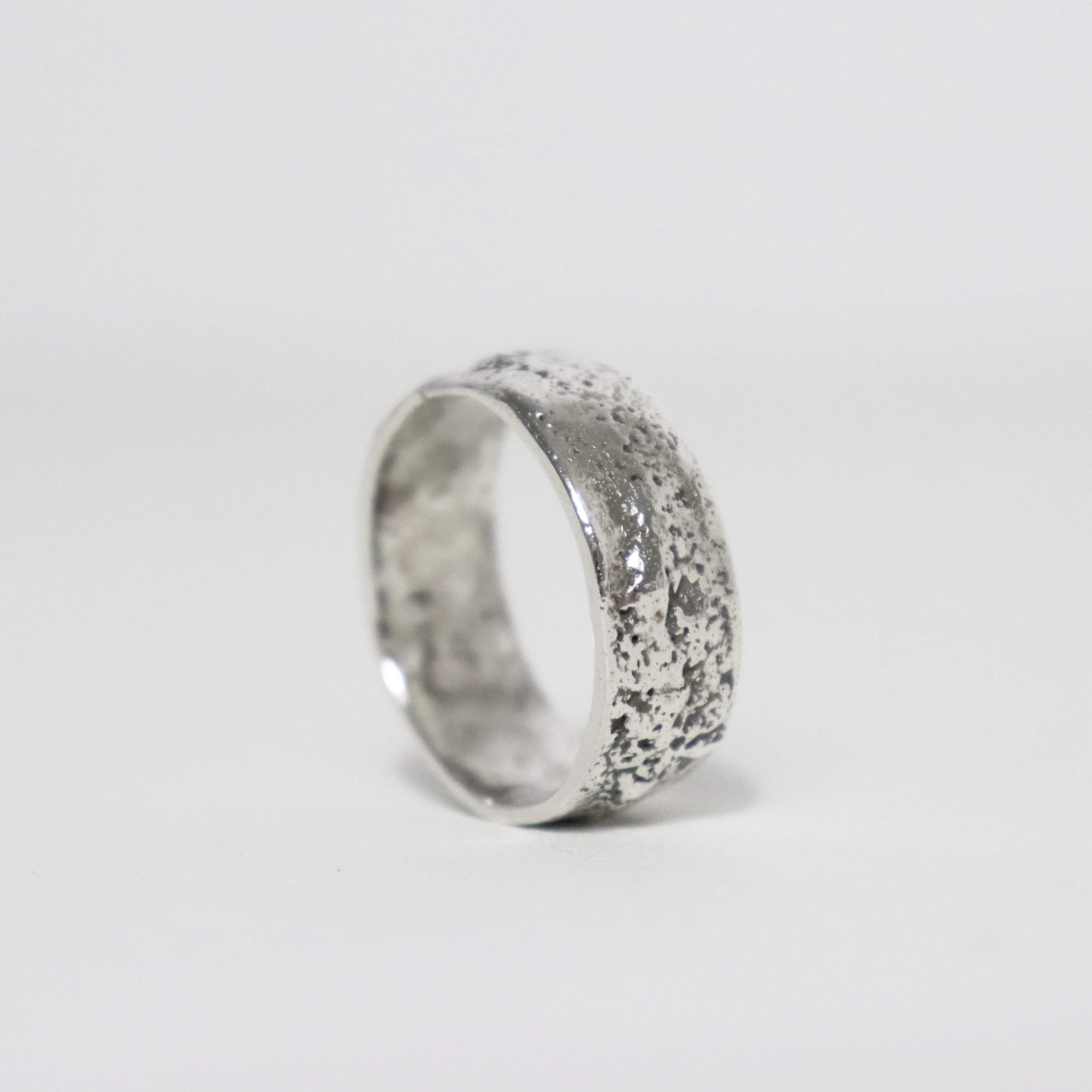 Stardust sterling silver thumb ring with wide band, irregular silver texture and smooth polished edges