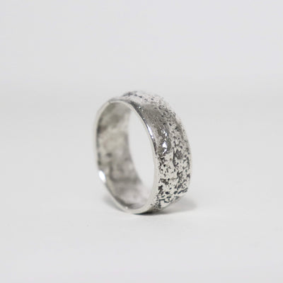 Stardust sterling silver thumb ring with wide band, irregular silver texture and smooth polished edges