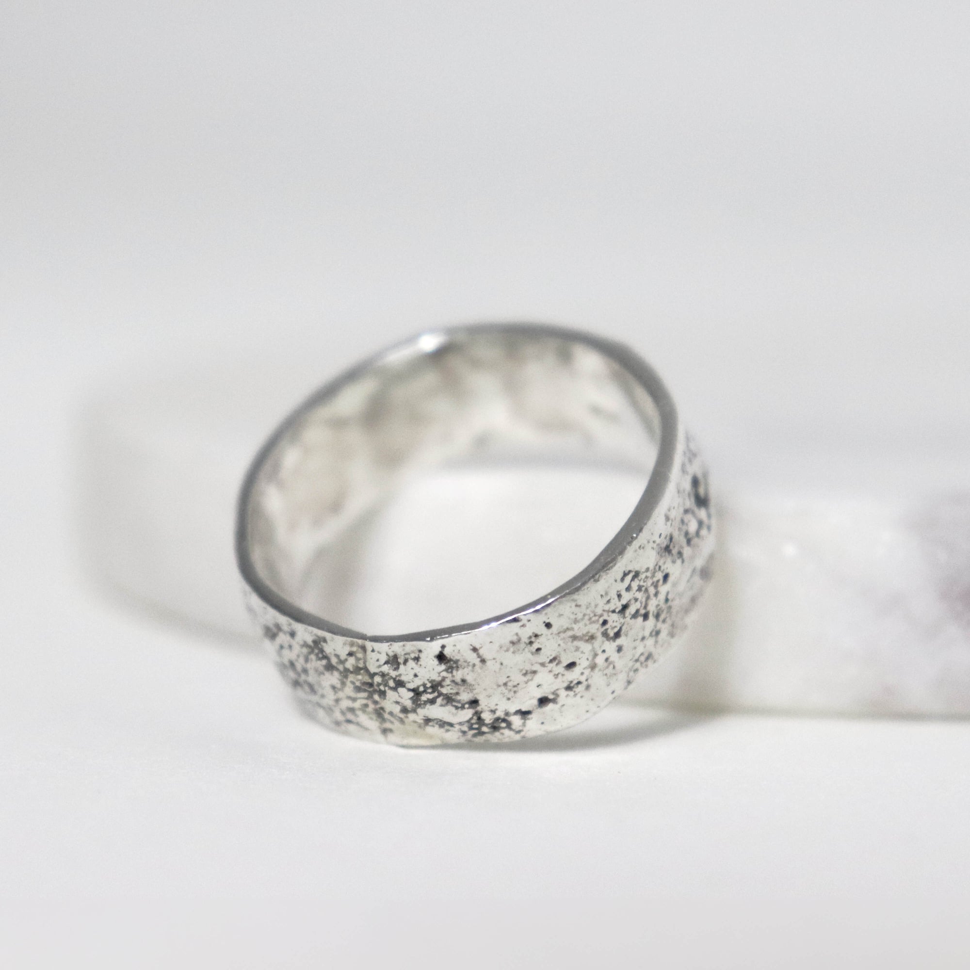 Oxidized sterling silver band ring with fused silver granules, sculptural textured surface and contemporary design