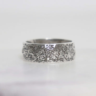 Handmade sterling silver men's ring with unique fused silver sawdust texture, wide oxidized band and polished silver interior.