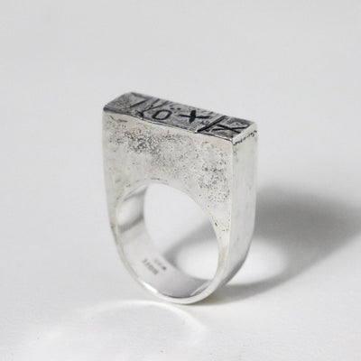 Handmade sculptural sterling silver statement ring with bold XXO markings, wide silver band and architectural design.