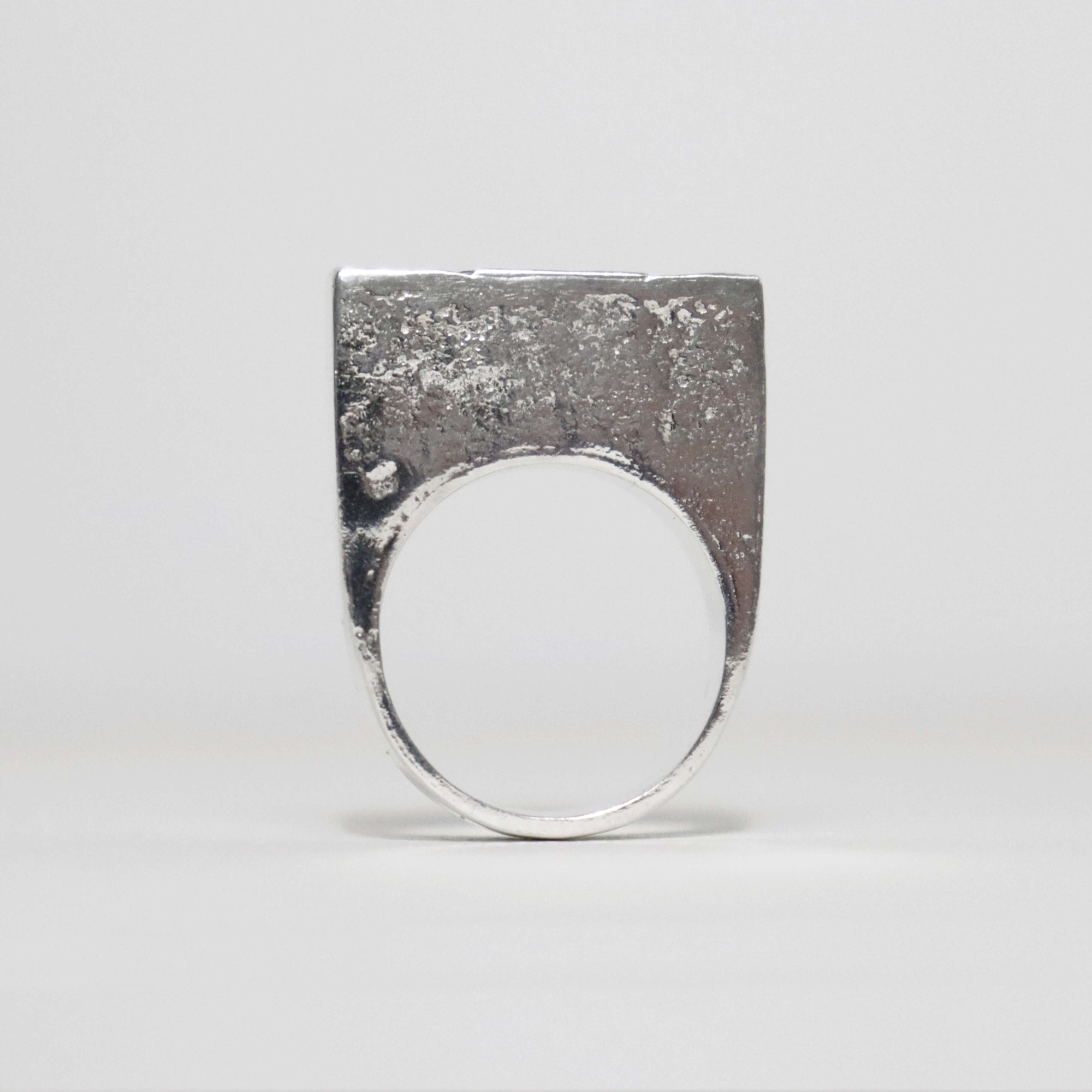 Textured sterling silver XXO statement ring with tall rectangular shape, sculptural design and polished inner band.