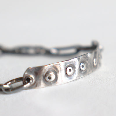easy to wear loose bracelet, oxidized silver, pattern of dots. Handmade by roff jewellery