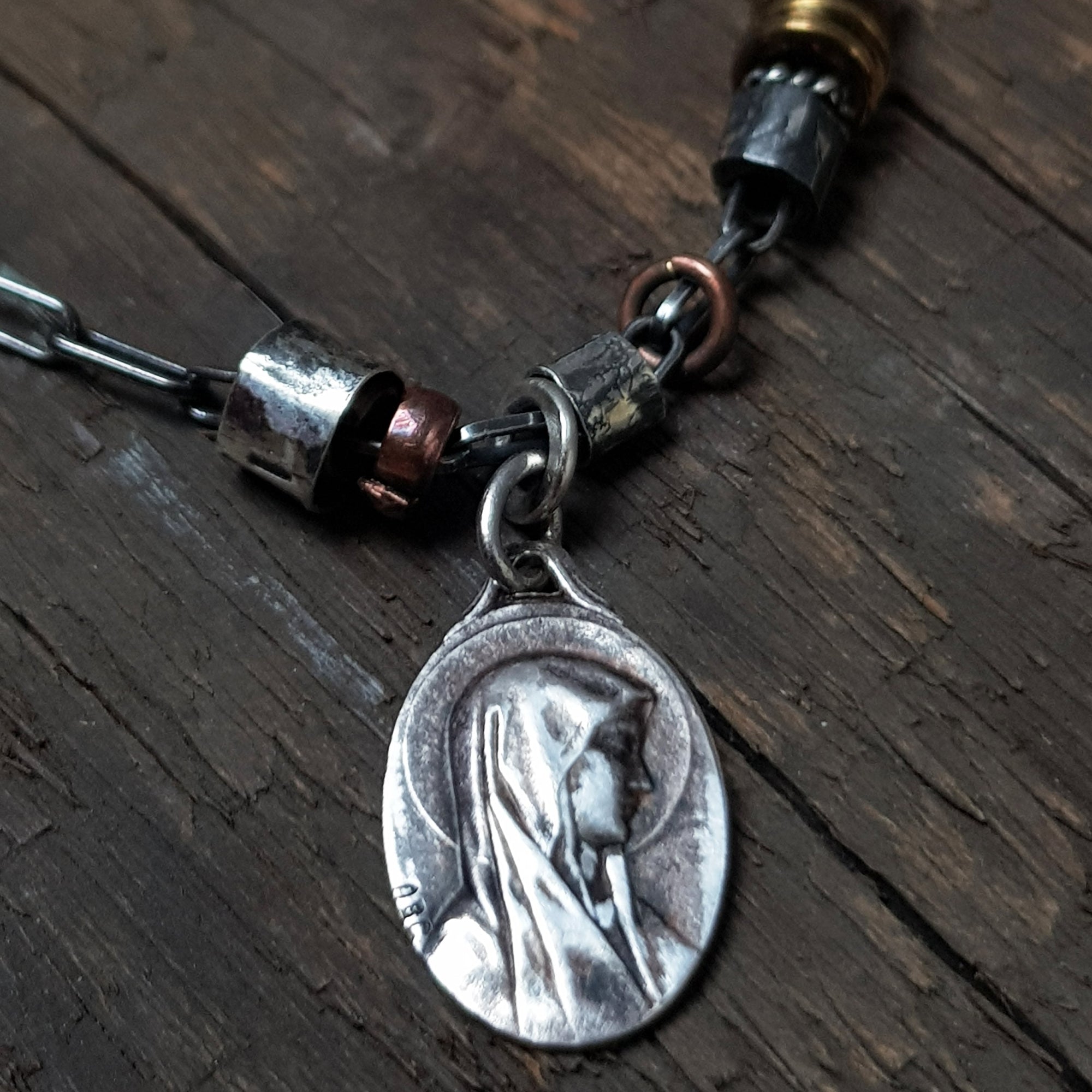 charm bracelet with sterling silver, copper and vintage jesus and mary charm. handmade by roff
