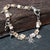 handmade silver bracelet with silver skull charms and fihbone beads, by roffjewellery.com