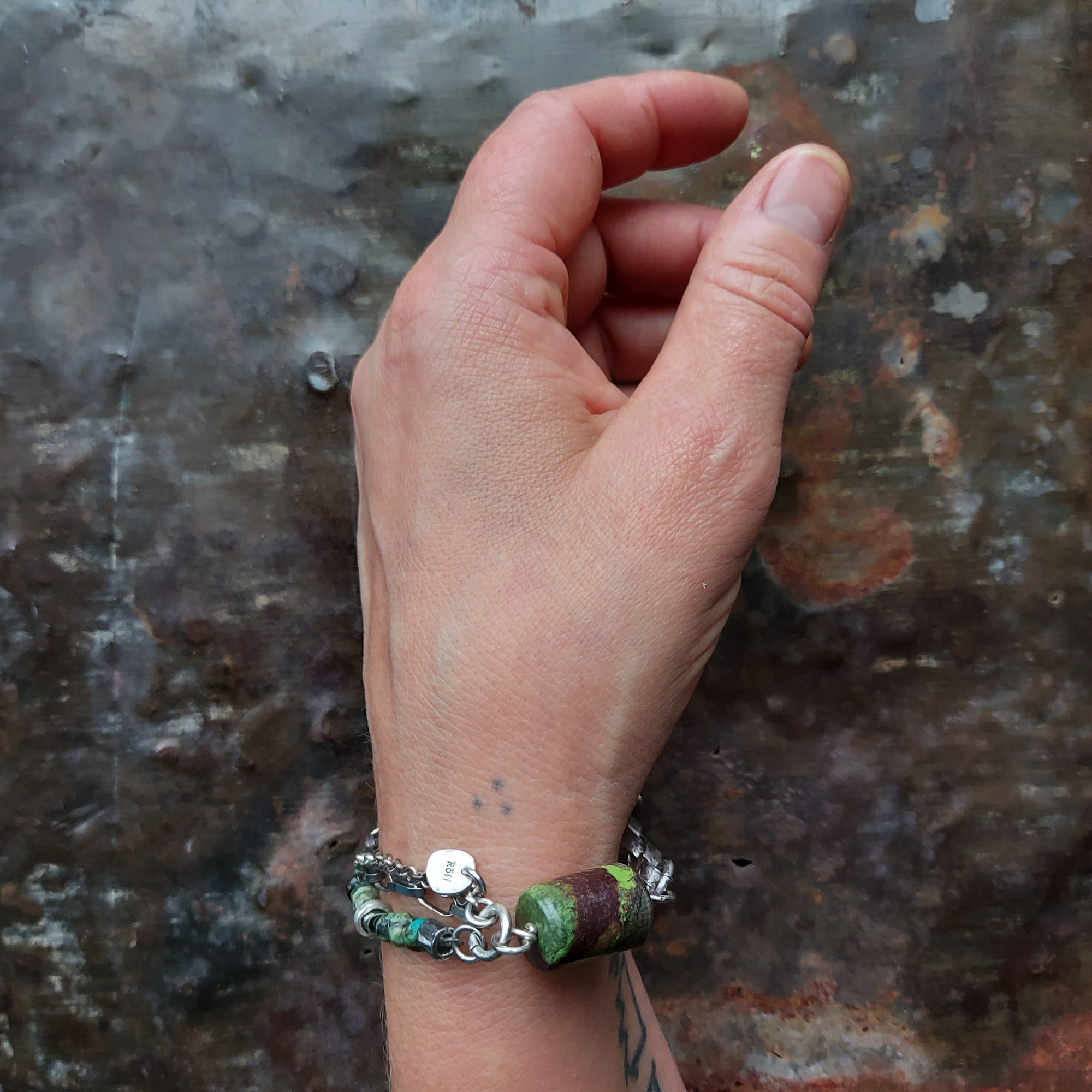 multistrand turquoise bead bracelet with large turquoise focal bead, silver chains, silver beads, handmade silver links and raw baltic amber beads