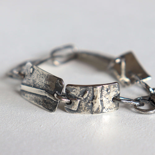 brutalist modern silver bracelet, textured plates, dark finish, handmade silver links by roff 
