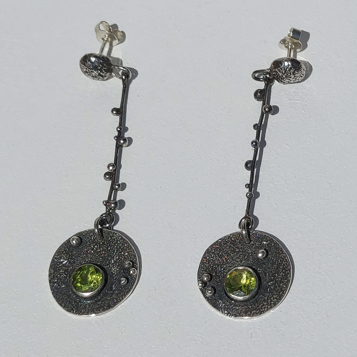 unusual dangle earrings with peridot, silver granules and texture, artisan made by roff jewellery