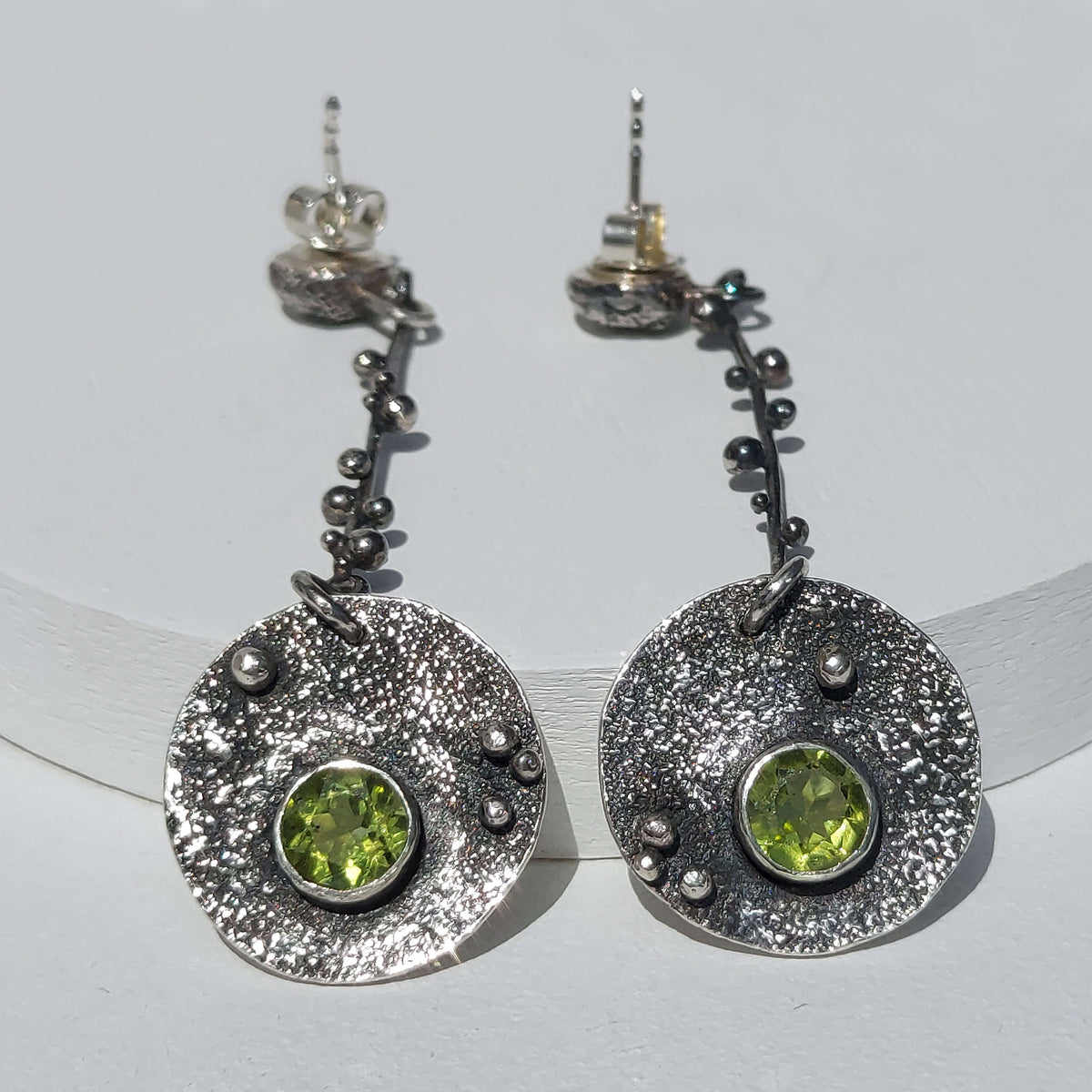 rough textured dangle earrings with peridot. handmade statement earrings by roffjewellery.com