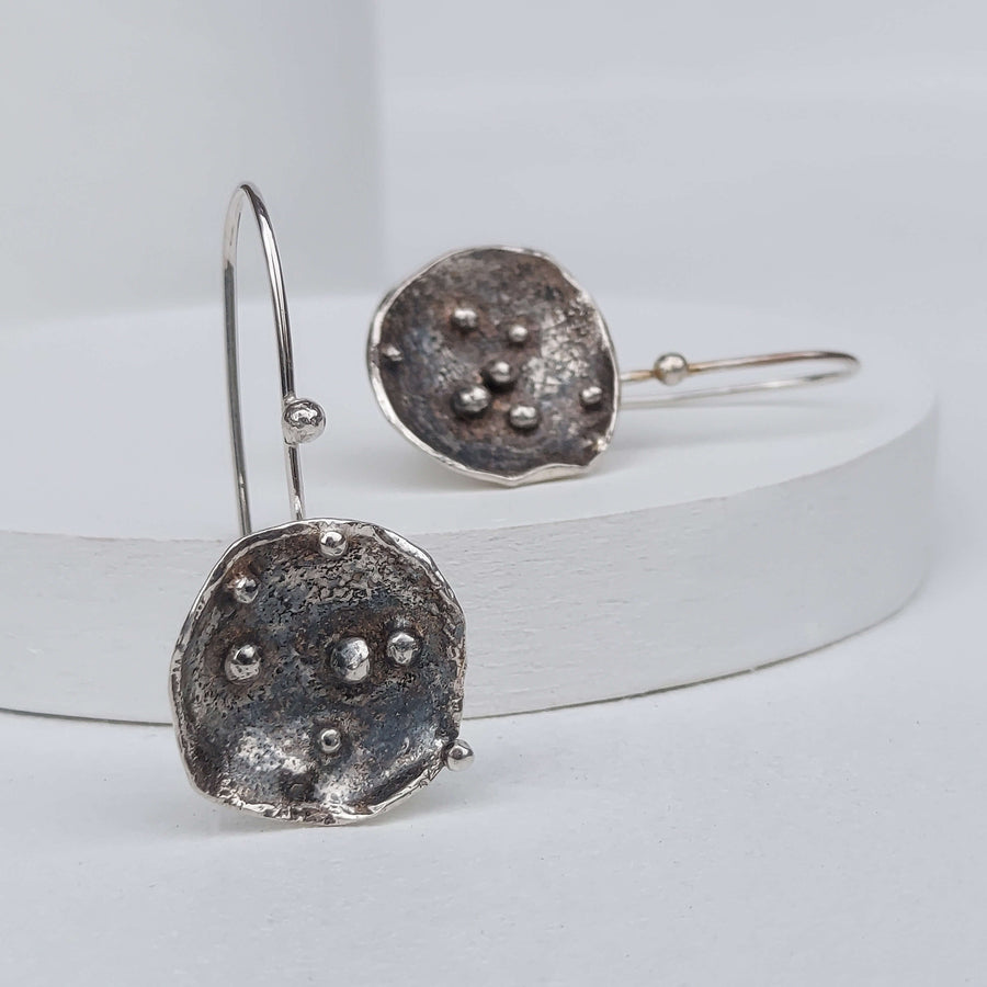 artistic dandle earrings made of 925 oxidized silver with silver granules.