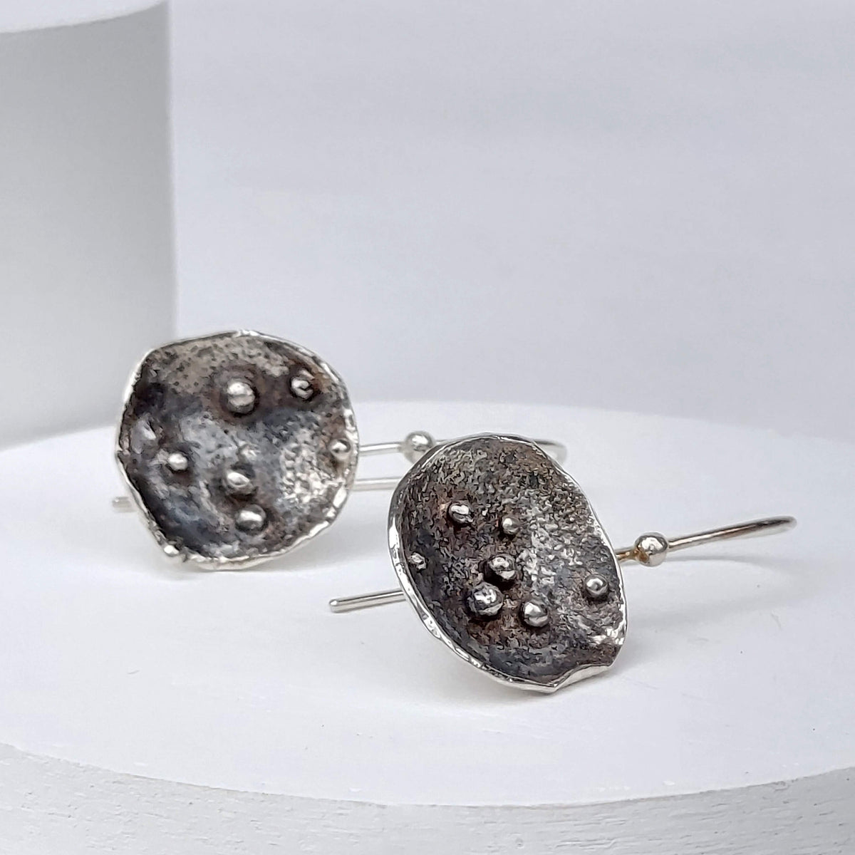Black silver drop earrings with texture and silver granules, handmade earrings by roff jewellery