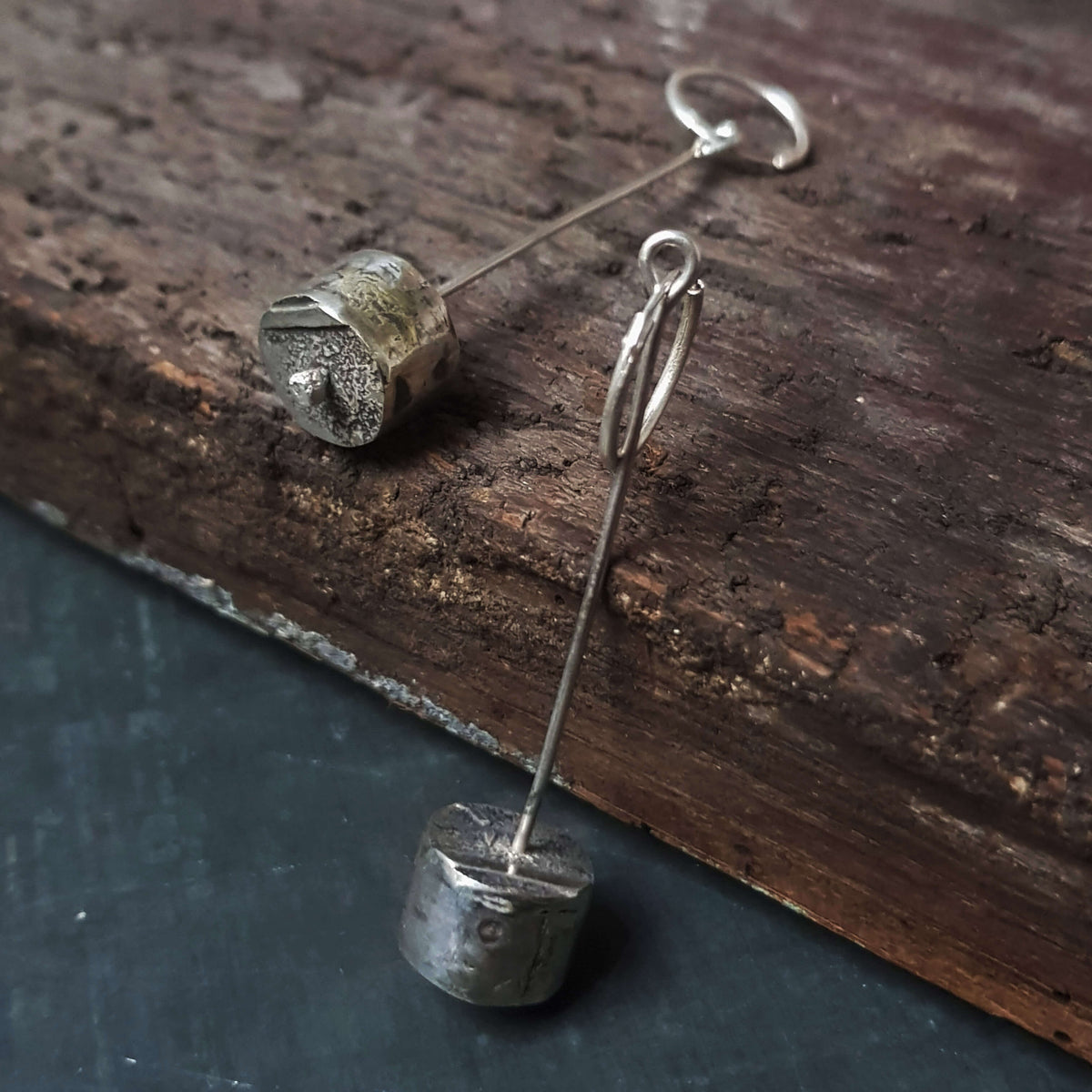Handmade silver cylinder shaped dangle earrings, rough pattern and texture, by roff jewellery