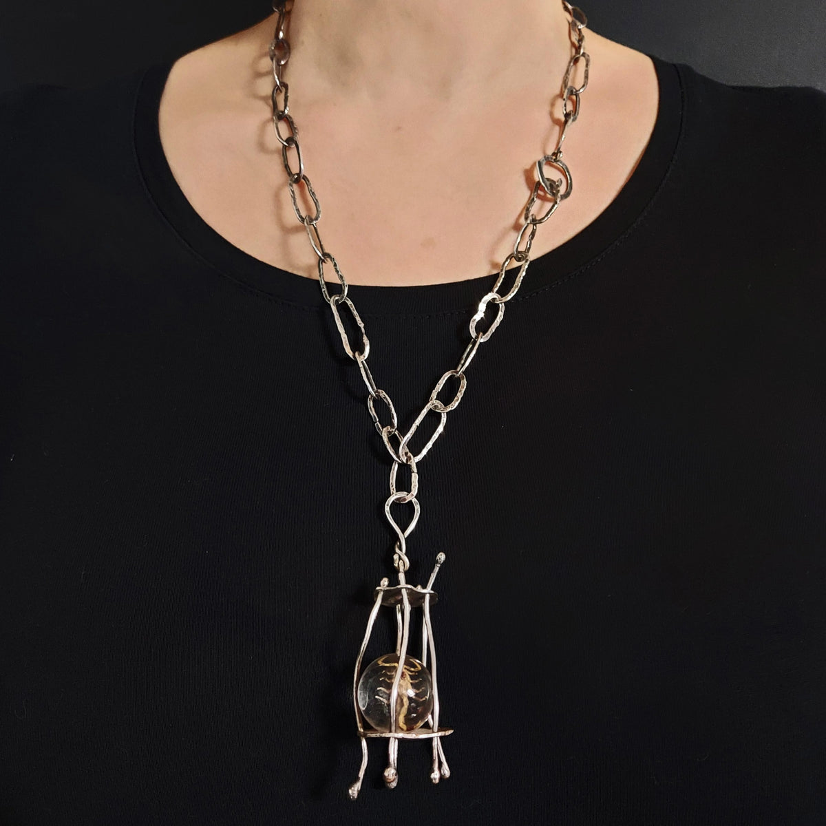 Hand forged silver chain with cage pendant and scorpion. handmade by roff jewellery