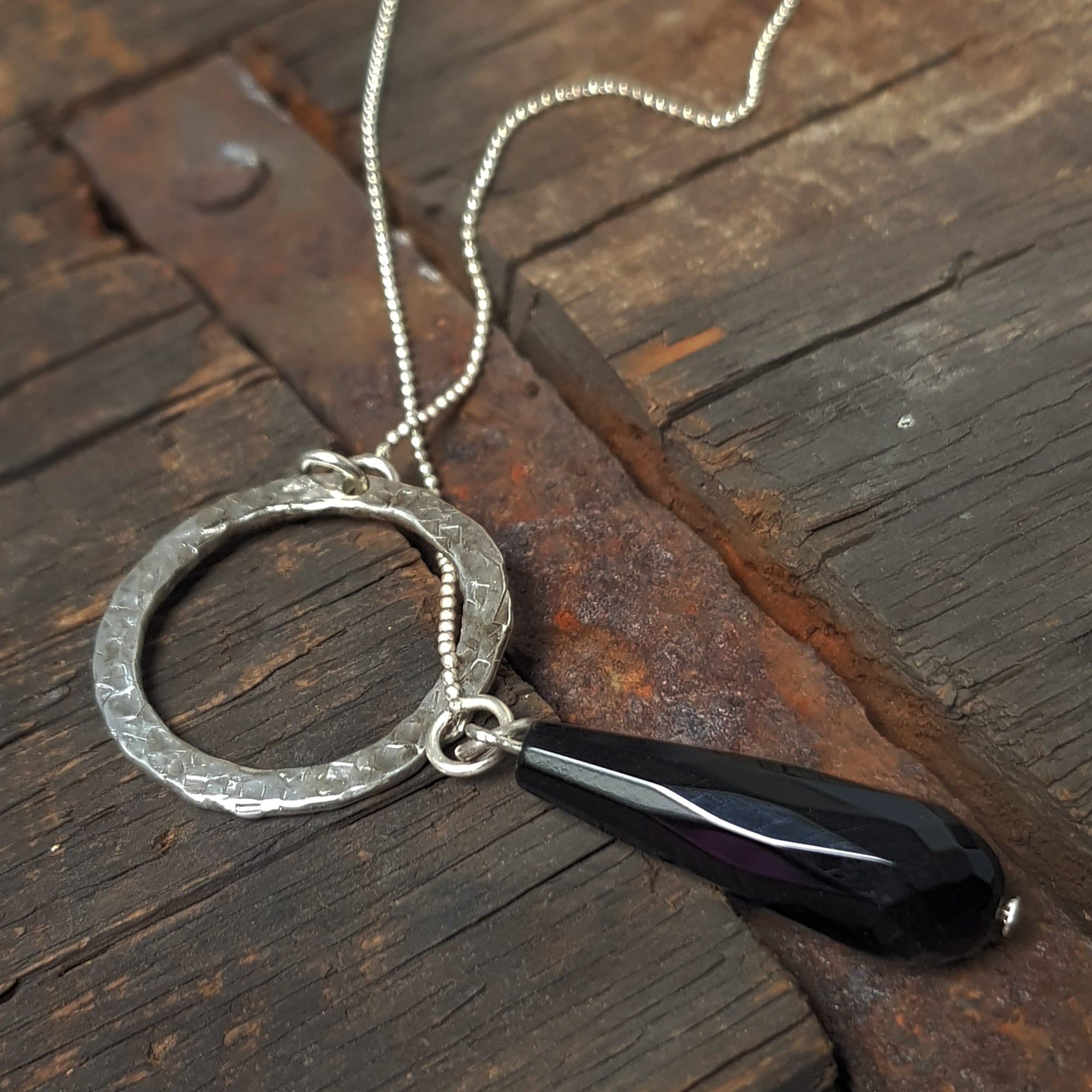 minimalist round pendant with pear shaped onyx bead on silver chain, handmade by roff jewellery