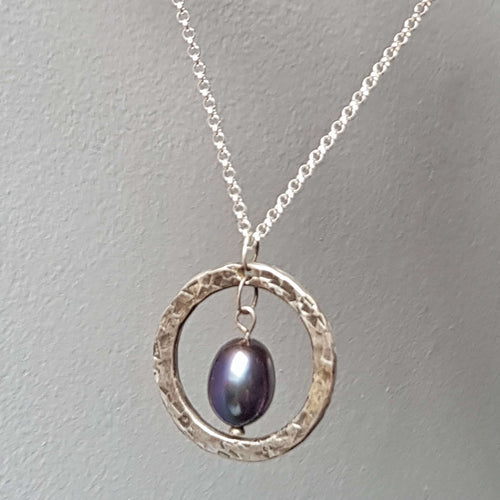  Hammered and oxidized circular silver pendant with blue black pearl, handmade by roff jewellery