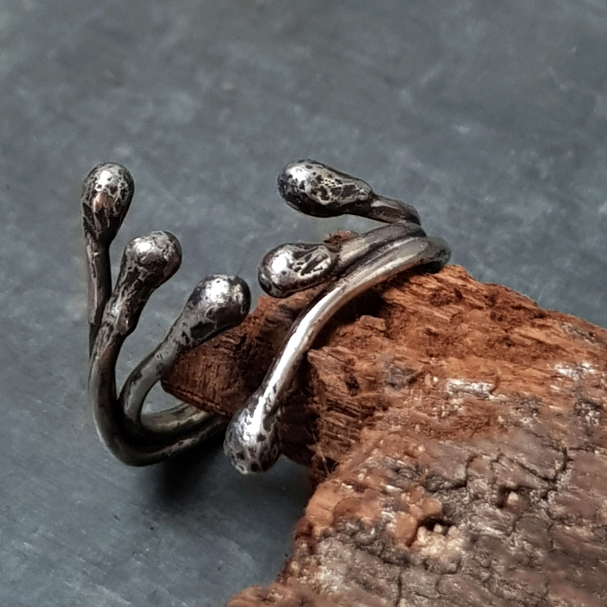 Oxidized silver wire ring with molten drop ends. open in the front, handmade to order by roff