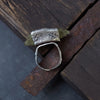 adjustable silver ring with rough texture with a raw yellow gemstone. rustic ring handmade by roff
