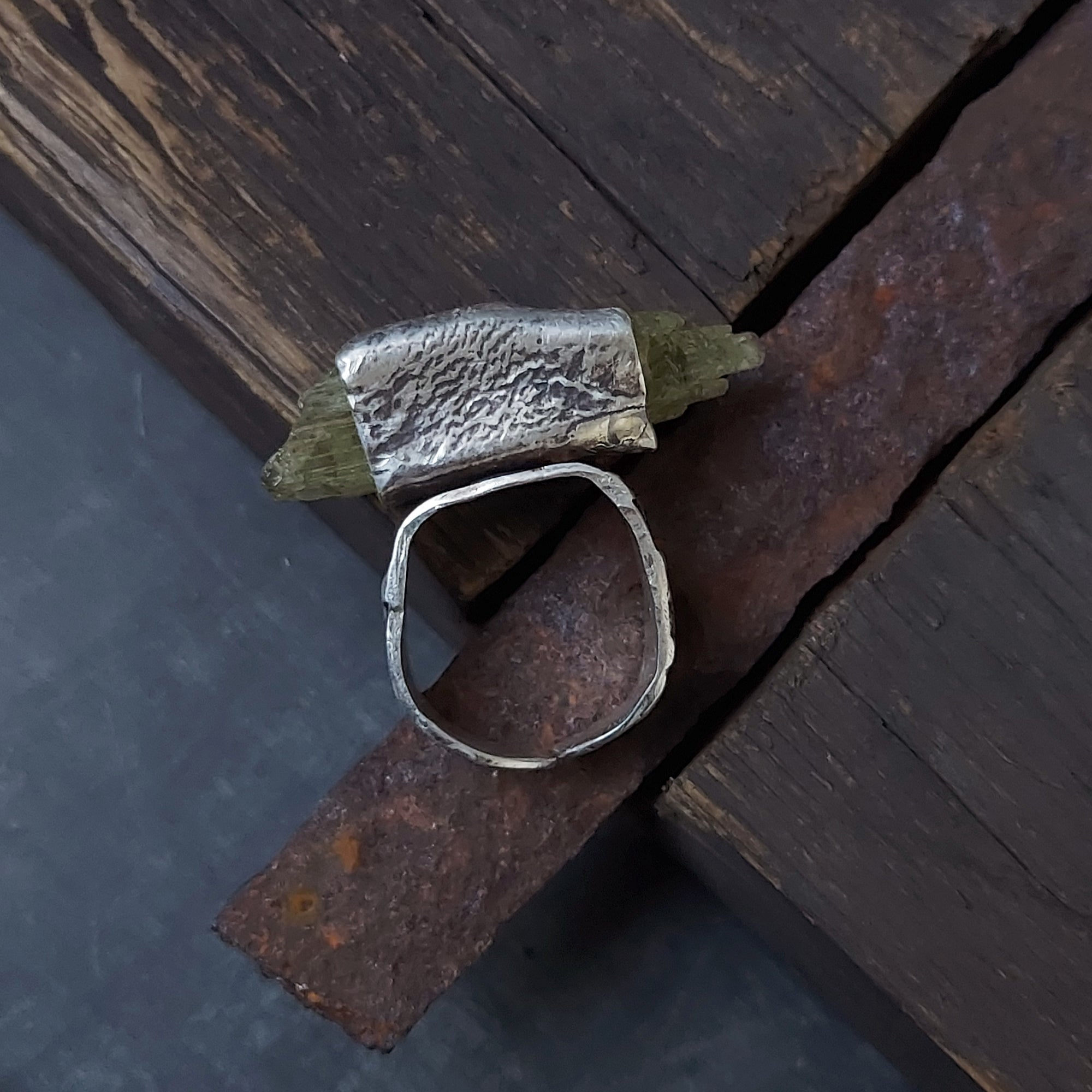 adjustable silver ring with rough texture with a raw yellow gemstone. rustic ring handmade by roff