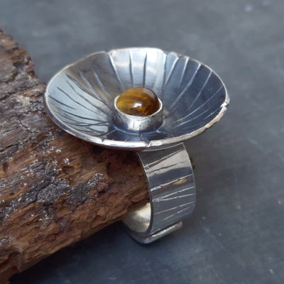 contemporary flower ring with tiger eye. statement ring,and a polished silver band, handmade by roff