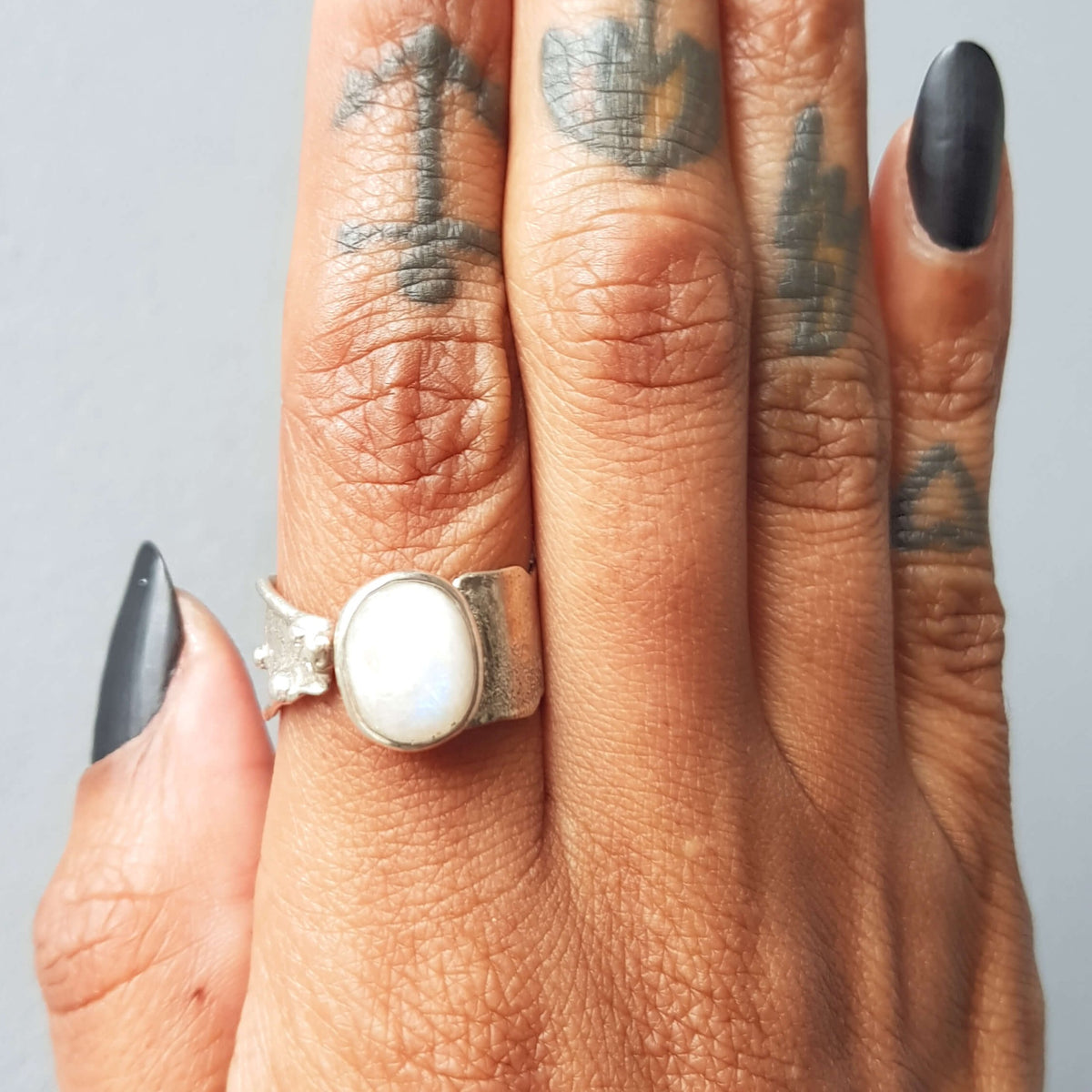 Organic texture silver ring with a blue oval moonstone cabochon handmade by roff jewellery