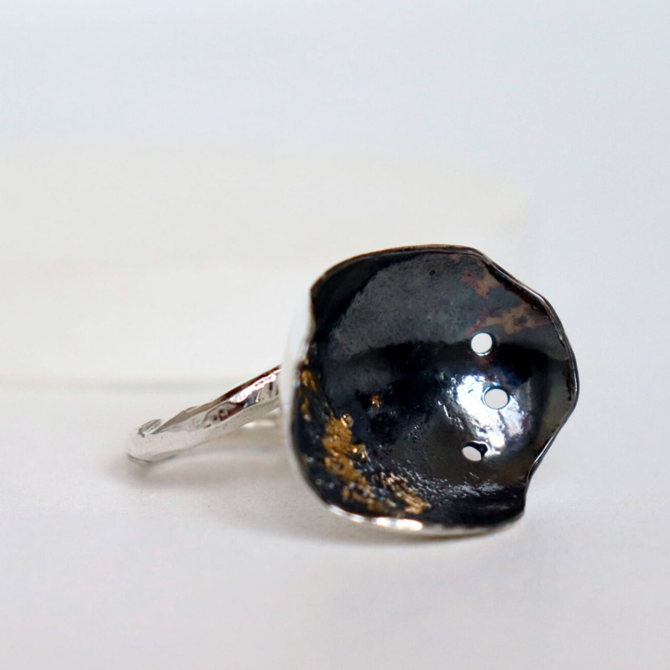 3 x 2 cm silver bowl on adjustable hammered silver ring. Oxidized with gold leaf, handmade roff ring