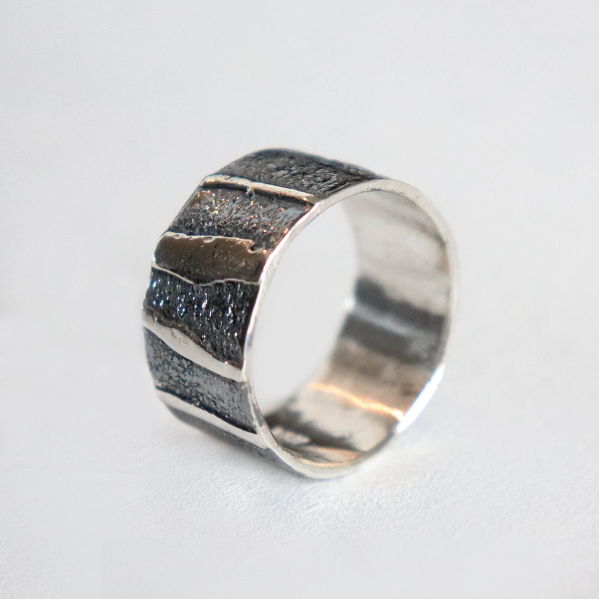 wide silver ring, dark patina and polished accent stripes. Handcrafted by roff